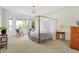 Spacious bedroom with four-poster bed and lake view at 9088 Nautical Watch Dr, Indianapolis, IN 46236