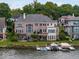 Lakefront home with brick exterior, multiple balconies, and dock at 9088 Nautical Watch Dr, Indianapolis, IN 46236