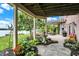 Relaxing stone patio overlooking the lake, featuring a fountain and pergola at 9088 Nautical Watch Dr, Indianapolis, IN 46236
