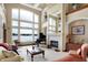 Living room with grand piano, fireplace, and waterfront views at 9088 Nautical Watch Dr, Indianapolis, IN 46236