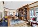 Bright home office with hardwood floors, built-in shelves, and a large desk at 9088 Nautical Watch Dr, Indianapolis, IN 46236