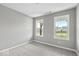 Well-lit bedroom with neutral walls, carpet flooring, and two windows at 7202 Bailow Ct, McCordsville, IN 46055