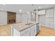 Modern kitchen with white cabinets, granite countertops and island at 7202 Bailow Ct, McCordsville, IN 46055