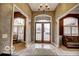 Elegant entryway with double doors, tile flooring and a chandelier at 7260 Josiah Ct, Indianapolis, IN 46259