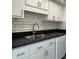 Modern kitchen with white cabinets and double sink at 1159 Canterbury S Sq, Indianapolis, IN 46260