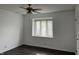 Bright bedroom with dark hardwood floors, window blinds, and ceiling fan at 1159 Canterbury S Sq, Indianapolis, IN 46260