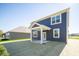 Rear view of a two-story house with blue siding and patio at 1678 Orchard Dr, Fortville, IN 46040