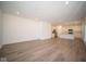 Spacious living room with kitchen view and wood-look floors at 1678 Orchard Dr, Fortville, IN 46040