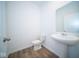 Simple bathroom with pedestal sink and wood-look floors at 1678 Orchard Dr, Fortville, IN 46040