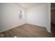 Bright bedroom with wood-look floors and large window at 1678 Orchard Dr, Fortville, IN 46040