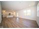 Open living room with kitchen access and wood-look floors at 1678 Orchard Dr, Fortville, IN 46040