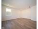Large bedroom with wood-look floors and a window at 1678 Orchard Dr, Fortville, IN 46040