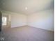 Large bedroom with neutral carpet and access to hallway at 1678 Orchard Dr, Fortville, IN 46040