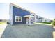 Two-story home with blue siding and covered patio at 1678 Orchard Dr, Fortville, IN 46040