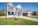 Two-story home with a blue exterior, two-car garage and landscaping at 1678 Orchard Dr, Fortville, IN 46040