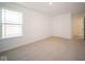 Bright bedroom with neutral carpeting and window at 1678 Orchard Dr, Fortville, IN 46040