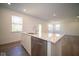 Open concept kitchen with island and white cabinetry at 1678 Orchard Dr, Fortville, IN 46040