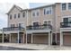 Rear view of two-story townhouses with attached garages and decks at 13094 Overview Dr # 5D, Fishers, IN 46037