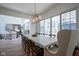 Bright dining room with a marble table, six chairs, and sliding glass doors at 1453 Andante Way, Westfield, IN 46074