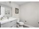 Clean bathroom with white vanity, toilet, and framed art at 1643 Sheldon St, Indianapolis, IN 46218