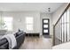 Bright living room with hardwood floors, and a view of the kitchen and stairs at 1643 Sheldon St, Indianapolis, IN 46218