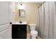 Basement bathroom with dark vanity, toilet and shower at 2150 Washington St, Columbus, IN 47201