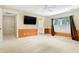 Spacious bedroom with carpet, ceiling fan, and large window with shutters at 2150 Washington St, Columbus, IN 47201