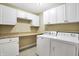 Laundry room with white cabinets, countertop, and washer/dryer hookups at 2150 Washington St, Columbus, IN 47201