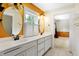 Bathroom with double vanity, large mirrors, and updated fixtures at 2150 Washington St, Columbus, IN 47201