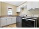Laundry room with modern washer, dryer, and white cabinets at 2150 Washington St, Columbus, IN 47201