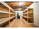 Unfinished basement with wood shelving for storage at 2150 Washington St, Columbus, IN 47201