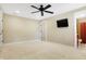Well-lit bedroom with ceiling fan, carpet, and private access to bathroom at 2150 Washington St, Columbus, IN 47201
