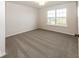 Bright bedroom with neutral wall and carpet colors and window view at 9317 Coopers Ln, McCordsville, IN 46055