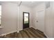 Bright entryway with dark brown door and wood-look flooring at 9317 Coopers Ln, McCordsville, IN 46055