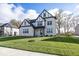 Two-story house with white brick and a gabled roof, showcasing a manicured lawn at 9317 Coopers Ln, McCordsville, IN 46055