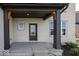 Covered porch with dark brown columns and a dark gray door at 9317 Coopers Ln, McCordsville, IN 46055