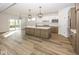 Open concept kitchen with a large island and stainless steel appliances at 9317 Coopers Ln, McCordsville, IN 46055