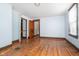 Hardwood floor bedroom with two doors and a window at 1117 N Parker Ave, Indianapolis, IN 46201