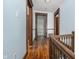 Upper hallway with hardwood floors and wooden doors at 1117 N Parker Ave, Indianapolis, IN 46201