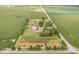 Aerial view of property showcasing home, detached garage, pond, and surrounding farmland at 14733 E 266Th St, Arcadia, IN 46030