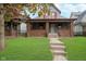 Two-story home with brick facade and a manicured lawn at 1117 N Parker Ave, Indianapolis, IN 46201