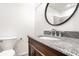 Bathroom with granite vanity, updated fixtures, and a toilet at 1739 Asbury St, Indianapolis, IN 46203