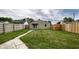 Backyard with a grassy area, wooden fence, and patio at 1739 Asbury St, Indianapolis, IN 46203