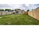 Backyard with a grassy area, wooden fence, and patio at 1739 Asbury St, Indianapolis, IN 46203