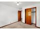 Spacious bedroom featuring wood closet doors and carpet at 70 Cossell Dr, Indianapolis, IN 46224