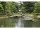 Charming wooden footbridge over a tranquil pond at 9100 S Us Highway 35, Muncie, IN 47302