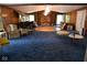 Spacious living room featuring a large stone fireplace and unique circular carpet at 9100 S Us Highway 35, Muncie, IN 47302
