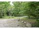 Small pond with wooden dock surrounded by lush trees at 9100 S Us Highway 35, Muncie, IN 47302