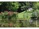 Picturesque pond with red flowers and footbridge at 9100 S Us Highway 35, Muncie, IN 47302