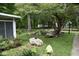 Landscaped yard with large rocks and mature trees at 9100 S Us Highway 35, Muncie, IN 47302